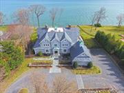 Your forever and private retreat awaits in Sea Crest Estates! Behind double wrought iron gates, travel the expansive pebble driveway to 9000 square feet of beautiful living space perched atop the Long Island Sound with commanding water views. Stunning custom kitchen flooded with sunlight offers high-end appliances, bright beautiful breakfast nook with walls of glass with dual gas fireplace, coffered ceilings, open family room and living room, formal dining room, home office, 7 bedrooms, 4.5 bathrooms and Crema Marfil Marble floors. First floor primary suite with custom closet and large bathroom, gas fireplace and sitting area. Second floor includes 4 bedrooms with en-suite bathrooms, spacious balcony to take in the sunrise and sunset,  2 additional bedrooms, back staircase and laundry on both floors for convenience and walk-up attic. Easy indoor-outdoor living is provided with tons of doors and windows. Expansive blue stone patio for outdoor enjoyment. Large lower level has 11 ft ceilings, a separate entrance and is clean, dry and ready to be finished or left for additional storage. The fortunate homeowner of this home is awarded access to Lloyd Harbor Beach with mooring rights, summer camp, tennis, pickle ball as well as Caumsett and Target Rock State Park for hiking, biking and fishing.