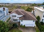 Welcome to 122 Eva Drive in the sought-after Lido Beach neighborhood! This stunning property offers not only a prime location with breathtaking water views but also direct access to the beach, making it the perfect coastal retreat. Step inside this expansive split-level home to discover generously sized rooms that provide a sense of spaciousness and comfort. The updated kitchen and bathrooms add a touch of elegance to the residence, ensuring a blend of functionality and style. The master suite is a true haven with its generous proportions, featuring high ceilings that create an airy atmosphere. Enjoy the luxury of a tremendous walk-in closet, a relaxing Jacuzzi bath, and a large sitting area adjacent to the master bedroom-ideal for unwinding after a day at the beach. The lower level of the home offers additional living space, including a sizable den and a well-appointed office-perfect for remote work or study. The convenience of a dedicated laundry room ensures that daily tasks are handled with ease. Stay cool and comfortable year-round with the brand-new central air condenser, enhancing the overall livability of this fantastic residence. The property boasts a serene ambiance, providing a peaceful retreat just steps away from the sandy shores.