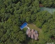 Located at the end of a private road, This spacious 4000 sqft. traditional home in East Hampton is perfectly situated on 5.5+/- beautifully landscaped acres bordering 160 acres of reserve. Less than nine minutes from Main Beach for beachgoers and five minutes to Main Street for Summer shoppers. This property was fully renovated in 2019 with all new mechanicals. It has four bedrooms with two master bedrooms, three and a half baths and an office space with a desk and printer, there is newly done white oak flooring throughout. This property has 360-degree views from both floors, the high ceilings and abundance of glass allows a flow of natural light. The outdoor dining area overlooks the backyard, It has BBQ appliances (professional smoker and gas grill) for the true grill-master. Multiple entrances lead to the garden, in-ground pool, all-weather tennis court and basketball court in this private multi-acre hideaway. The downstairs&rsquo; master bedroom has double glass doors to the backyard with its own private porch and hammock overlooking the tennis area. This master bath is a personal spa with an oversized jaccuzzi tub and double shower. An attractive open staircase leads to another private master suite with its own full bath. The second level includes two additional guest bedrooms sharing a full bath. All offers welcomed