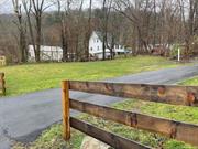 Village of Ellenville Lot improved with a blacktop driveway and fence that borders the front of the lot. R1 Zoning for a 1 family Residential home that meets the proper setbacks.