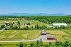 Welcome To The Ponderosa! The horses aren&rsquo;t the only ones who will love this special slice of Heaven with its rolling meadows and majestic Catskill Mountains views.  Nothing to do here but enjoy easy living in this expansive Contemporary Ranch style home with plenty of room to roam. Open concept with a light filled Living Room, Granite Kitchen with stainless appliances and Breakfast Bar happily marries a formal Dining area. The gleaming hardwood floors run throughout the living area and into 2 of the 3 bedrooms. The Main Bedroom is a tranquil place to rest your weary head and the tiled bath invites you to enjoy a soothing hot bath in the garden tub. Two walk -in closets are perfect for those who love clothes, shoes and organization. The additional bedrooms are tucked away on the opposite side of the home, which allows guests or kids their own privacy with another full tile bath. Laundry Room is conveniently placed on main level. On the lower level is an exciting media room that could easily work for a home office or playroom. A 3rd Bath is a bonus, and an additional room is ready for hobbyists, kitchenette or home business. Appreciate the highly efficient mechanicals plus Central Air, and generator hook up. Two car garage easily accommodates truck or SUV. Enjoy lazy summer days soaking in the vistas from the wraparound front deck or an afternoon barbeque on the back deck and then toast smores in the evening on the patio around the firepit while listening to the peepers. The RED BARN is all ready for your herd with 6 oversized stalls; tack area, in place water; separate electric and RV hook up. Paddocks are separate and encompass the 10.9-acre farm with ride in shed. Property features a 140 x 220 ft. riding arena in the rear of the parcel against the Catskill mountain views making this the Equestrian dream. Set way back from country road and convenient to everything great about the Hudson Valley. Red Hook SD. Cows, Goats, Chickens, and all Furry Friends also welcome! This property has all the space for your dream Hudson Valley mini farm.