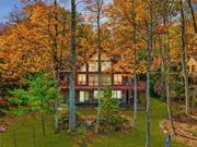 Here at 164 South Shore Drive it&rsquo;s hard not to first be taken by the wall of windows between you and the expansive and elevated view of Wolf Lake. The great room, consisting of the living room, dining area, kitchen and breakfast nook, is flanked by the widest section of the lake. Needless to say, the large lakeside deck has one of the best vantage points there is in this community. Something worth noting, the full walkout basement with 8.5 ft ceilings has elevated lake views of its own; an amenity that only the marriage of right property and home design could provide. Thoughtfully designed with a first-floor primary suite and two large bedrooms with walk-in closets and large loft space upstairs will allow family and guests to enjoy the view from almost anywhere in this home. Upon looking beyond the obvious of view, form and finish, you will begin to appreciate what you don&rsquo;t see that has gone into the construction of this home: The seller, a contractor, supervised the build himself and did much of the work; the rare home, built by builder for himself and his family. An over-engineered foundation, radiant floor heating on the first, second and basement levels, cherry cabinets and floors, cedar ceiling, high efficiency windows and ductless air conditioning throughout are just a few items of the full list of unique features and amenities available to all prospective buyers. Wolf Lake: 1, 800 private acres of untouched forestland, miles of maintained hiking trails, three pristine spring-fed bodies of water and clubhouse with full calendar of events. Wolf Lake is a community that is unmatched in its natural amenities and desirability while just 90 min from the GWB. One time Wolf Lake membership fee of $5, 250 annual dues of $1, 050.