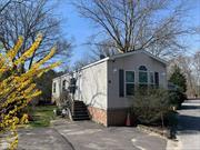 This East Quogue mobile home is the perfect for Year Round living or a seasonal getaway, The home was manufactured in 2019. Large eat-in kitchen, living room, two bedrooms and one bath.The yard is nicely landscaped on this over sized corner lot. Large shed for storage, Central air, central Vac & washer/dryer complete the package. The Lot fee of $600 includes Garbage, maintenance of common areas, underline taxes, cesspool, snow removal and water. Don&rsquo;t miss this one.