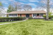 Set on a tree-lined street in the desirable Smithtown Pines, 51 Woodland Lane presents a pristine facade that reveals a stately elegance inside. Pass through the double doors of this ranch to an entry with gleaming hardwood floors that connect the living spaces in the open floor plan. Dentil molding, gracious columns, and arched doorways create a genteel air that&rsquo;s both luxurious and comforting. To the right of the foyer lays your ample formal dining room with crown molding, recessed lighting, and sun-filled windows with an easy flow to the chef&rsquo;s kitchen. The eat-in kitchen is nothing short of exquisite with a brilliant skylight, exposed beams, high ceilings, granite counters, stainless steel appliances, abundant cabinets, and a center island. The adjoining great room provides a lovely respite for the day&rsquo;s end with vaulted ceilings, covered beams, shiplap walls, windows galore, and a brick feature wall encasing a cozy woodburning stove. Sliders open to the patio, perfect for al fresco dining. A main-level primary en suite offers a king-sized bedroom, a full bath, and dual closets. Four additional bedrooms and a full hallway bathroom complete this floor. Mostly finished, the full lower level will end rainy-day boredom with a rec room with a fireplace and an outside entrance, a media room, a bar, a half-bathroom, and a laundry/mechanicals room, as well as an attached 2-car garage and storage. The home also includes central air conditioning, inground sprinklers, gas heat, and a new driveway. Near all parkways, shops, and Town of Smithtown beaches. Request your private viewing today!