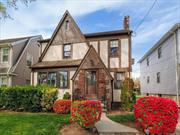 Welcome to beautiful Floral Park! This lovingly maintained Tudor sits on a wonderful block in the heart of the Village. Enter through the foyer into an elegant formal living room with wood-burning fireplace with a den/office to the side. The large dining room opens up into a huge, renovated eat-in kitchen with new appliances and a cozy breakfast nook, powder room and an enclosed porch - the perfect spot for morning coffee or relaxing after a long day. Second level features a large primary bedroom, two additional bedrooms, a gorgeous brand new (2023) hall bath and a finished, walk-up attic with plenty of bonus space and storage. The semi-finished basement can be the perfect hang-out space with separate laundry and utilities. The private backyard is ideal for entertaining with a lovely patio. Great location within blocks to shops, schools, restaurants, L.I.R.R. and more. This classic Floral Park beauty features gleaming hardwood floors and vintage charm throughout plus newer windows, roof and plumbing. Esteemed Floral Park-Bellerose schools. All this magnificent home needs is your personal touch to make 299 Carnation your forever home!