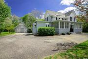 This lovingly restored turn-of-the-century Victorian farmhouse blends timeless charm with modern conveniences and is enhanced by a private lush acre with a garden. Step inside the welcoming enclosed porch and enter a historic masterpiece featuring 9-foot ceilings, intricate millwork, Koa and Brazilian Cherry hardwood flooring, and stained glass windows. Relax by the gas fireplace in the expansive living room, entertain guests in the formal dining room, and soak in the natural beauty of the enchanting sunroom. The tastefully remodeled kitchen harmoniously combines the character of the home with functionality, including white beadboard cabinetry with Eastlake-style hardware, premium stainless-steel appliances, including a Viking stove and Caesarstone seamless countertops. Recent updates, such as a new roof and natural gas heating conversion ensure comfort and peace of mind. Outside, the tranquil rear yard beckons with its park-like setting, adorned with perennial flowers and fruit trees. With a two-stall barn and tack room offering endless possibilities and close proximity to public transportation including the Smithtown LIRR station, local beaches and state parks, a wide variety of restaurants, and esteemed educational and medical institutions like Stony Brook University and Hospital , as well as Smithtown Schools this property offers the perfect blend of serenity and convenience.