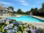 Very spacious, natural light filled custom designed beauty just 3 minutes to gorgeous, private community LI Sound beach. 44&rsquo; x 24&rsquo; heated, saltwater pool. Bright & airy open concept design LR/DR/KI with sliders to expansive deck overlooking private, fully fenced, park-like grounds. Upstairs has a large, 2nd living room with billiards, foosball, large tv plus sliders to private deck. 2 primary ensuites - one on each level. 2nd floor primary has its own entrance, living room, wet bar, refrigerator and wall of sliders to deck. Home is impeccably maintained and tastefully furnished throughout. Fine dining, marina & state park and Cross Sound Ferry just down the road. A scenic 9 mile drive to Greenport with its fine dining, cafes, waterfront park, boutiques & galleries, golfing and more. Rental Permit #1117. Exp. 5.6.26.