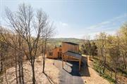 Newly built with craftsmanship and attention to detail, this contemporary home offers a modern take on country living. The entry takes one in to the dramatic great room with soaring ceilings, radiant heated polished concrete floors and french doors opening to a spacious blue stone terrace. This room provides for living with a woodstove for cozy gatherings and dining showcasing a chefs kitchen with custom made cabinetry, marble counter tops and Miele appliances. The primary bedroom is found on this level and has an ensuite bath and access to the outside patio. Additionally on the first level, there is a den/office and a powder room with laundry. Upstairs there is hardwood flooring and two generous bedrooms both with cathedral ceilings and one with captivating views of the distant hills. A beautifully appointed full bath completes this floor. The outdoors is open with plenty of space for lawns, gardens or a pool and has pretty vistas looking to the south and the east. All is located just minutes to Rhinebeck, convenient to the Taconic Parkway and all of the food and culture to be enjoyed in the Hudson Valley.