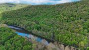 The East Branch of the Delaware River does not disappoint. Located just below the confluence of the Beaverkill and the East Branch, this stretch of river is renowned for giant wild brown and rainbow trout. Here you have almost a full mile of riverfront with a variety of pools, runs and riffles. There is a fairly decent access to the river too. Roughly 12 acres on the river and the upper side of the road has 66+ acres of mixed hardwoods and trails. Excellent hunting and a great place for an upstate cabin. Easy access to route 17. You&rsquo;ll want to get your feet wet on this one.