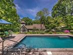 Welcome to 1000 Oaks, a quintessential Rhinebeck country home! This property,  nestled on 6.8 acres of land, consists of a 3200+ sq. ft. main house, an 800 sq. ft. recording studio, and a heated gunite pool. It also offers a lovely seasonal mountain view.  Step into the evolution of 1000 Oaks. From its humble beginnings as a little hunting cabin in the woods, it was transformed into a cozy home of his own by a well-known local contractor, showcasing exceptional building quality. By 2008, the current owner reimagined the entire property, elevating it to a unique contemporary home while emulating its original building quality and adding artistic touches.   Like many a great home that embodies a living philosophy, 1000 Oaks embraces and reflects Wabi Sabi, a time-honored Japanese philosophy. It means accepting imperfection as part of life, following the lead of the natural surroundings, and finding beauty in humility and simplicity. Natural landscaping is preserved, wildflowers are welcome and cultivated, wood, field stones, and bricks are widely utilized, and low-contrast earthy colors are applied inside and outside. The goal is not to reach perfection but to curate harmony: living here is to be in touch with nature and in tune with ourselves.   Here are a few highlights: the family room has an attached full bath. It can host visiting guests; the tower&rsquo;s second floor is an office with two workspaces; the third floor is used as additional activity space where you can survey the property through the walls of windows. The fully functional music studio is a musician&rsquo;s dream and provides a multitude of potentials; the pool is a delight of summer. A new pump and new heater are standing by and will be conveyed. Each year, from November to late April, you can watch the sun setting behind the indigo Catskill Mountains. In the summertime, after the leaves grow in, the property feels secluded and very tranquil. Yet, it is only 6 miles from the center of Rhinebeck village, six miles from the Taconic Parkway, and a stone&rsquo;s throw from the Rhinebeck Performing Art Center.   No matter what brings you to Rhinebeck/Hudson Valley to find a weekend getaway, establish your year-round home, or start a new chapter in life we invite you to experience 1000 Oaks. Most likely, you will enjoy its natural beauty. Perhaps you will find its earthy presence peaceful and relaxing, or its warm refined rustic aesthetics speak to you. It could strike a chord with you, and home is where your heart is.