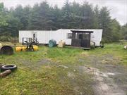 25x25 ft garage, and smaller old mobile home on property can be replaced. has electric and well and septic small stream in rear , level lot consisting of 2 parcels lot size total is .96 acres.