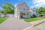 Charming 3 Bedroom 2 Bathroom Colonial With High Ceilings, New Bathroom, Enclosed Porch And Detached 4 Car Garage With Separate Electric Meter All Located Right In The Heart Of Amityville Village Close To Restaurants Bars & LIRR