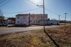 Large warehouse, small two-story building, metal pole barn. Warehouse approximately 37, 000 sq. ft., Storage barn approximately 5, 560 and a 2 story office building approximately 1, 000 sq. ft. The main warehouse is estimated to be over 95 yrs old at its oldest section, with several additions added over the years. Approximately 37, 000 sq. ft. of useable space. Only approx. 1/3 of bldg. is being realistically used and that consists of two large refrigerator/coolers and associated loading bay area. The balance of the building is either unusable due to condition or is simply not needed. The main focus over the past years has been food distribution. There is so much potential for redevelopment or lease out.