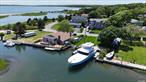 Experience Summer Camp Bliss at 2335 & 2480 Minnehaha Blvd, Southold Step into a world of endless summer fun at this quintessential summer camp property, perfectly sited on two lots with expansive bayfront views featuring picturesque sandbars and a pristine beachy landscape. This Nantucket-style cedar shake home, with its charming Dutch doors and expansive decks, invites you to soak in the refreshing sea breeze and panoramic vistas of the creek, bay, and the impressive yacht docked right at your doorstep. The open floor plan seamlessly connects the gourmet kitchen to a cozy living room equipped with a built-in wet bar, where you can enjoy your favorite drinks while gazing through the picture window at the serene waters. Originally designed as a main floor master suite, the home&rsquo;s addition now serves as a state-of-the-art golf simulator room, adding a playful twist to luxury living. Embrace your love for the water with riparian rights and a private dredging permit valid for ten years, ensuring your dock remains in prime condition for your 66&rsquo; yacht. A waterside storage shed keeps all your water toys, from paddleboards to kayaks, within easy reach, making spontaneous adventures a breeze. The current black lab resident epitomizes the joy of this property, eagerly chasing after paddleboards and kayaks, and even racing across a nearby island to lead the way back into the water. It&rsquo;s a true testament to the playful spirit that defines this unique home. For those moments when you seek tranquility, multiple decks, patios, and a private man-made beach on Corey Creek offer serene spots to unwind. Alternatively, the natural beach of the Laughing Waters homeowners association on Hogs Neck Bay provides an idyllic setting for relaxation, where the sounds of the residents laughing epitomize the joyous community spirit. This property is not just a home; it&rsquo;s a lifestyle, where every day feels like summer camp. Perfect for those who cherish waterfront living, active recreation, and the simple joys of nature, 2335 & 2480 Minnehaha Blvd is a dream come true for both humans and their furry friends. Don&rsquo;t miss the chance to make this enchanting retreat your own and create memories that will last a lifetime.