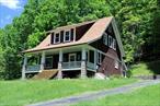 Arts and Crafts home on 2 acres close to the Hamlet of Callicoon! Original condition with Fir floors and Chestnut trim. Kitchen has plenty of original cabinets with attached pantry/built in cabinets- this room also has half bath. Large formal dining room with built in cabinet. Beautiful staircase leading to upstairs with 3 bedrooms -all with large walk-in closets. Full bath has hand painted tiles with clawfoot tub and shower. Full attic perfect for home office/den seeing you have High Speed Internet to work from home. Basement has workshop and walk-out entrance. Breezeway leads you to an attached oversized 2 car garage. Beautiful stone walls and woods behind home including fireplace for outside entertaining. Paved driveway. Minutes to the Hamlet of Callicoon and the Delaware River for restaurants, movie theater and shopping. This home is waiting for someone to give it new love!