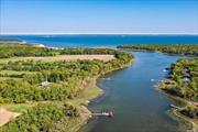 Wells Landing - Introducing a once in a generational, rarified 2.2 acre flat waterfront estate like property featuring panoramic and unobstructed year round water-views. Perfectly positioned on Richmond Creek, Wells Landing presents a peaceful and idyllic retreat with deeded dock as well as direct waterfront access to The Peconic Bay. The property offers a unique and dynamic opportunities to either keep, renovate, expand or build your dream home. The current residence features bright and well proportioned spaces including a lower and upper living level. The primary second floor living space boosts walls of glass windows with picturesque water-views, floor to ceiling exposed brick fireplace and an inclusive open concept eat in kitchen. A large second story deck off the living room creates a perfect integration of indoor and outdoor living featuring expansive water, farm and vineyard views. The home features two bedrooms and two full bathrooms nicely tucked away from the main living spaces. The property features many mature specimen plantings and lush foliage creating a very secluded and private oasis. The property is located just moments away from Sound beaches, some of the North Forks most renowned vineyards as well as close proximity to Greenport Village & Shelter Island.