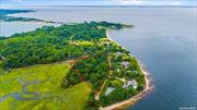 This property offers 5.22 acres bordering a Private Beach with Views to Cove Neck and 20 Acres of Bird Sanctuary