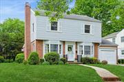 Welcome to this charming colonial, situated mid-block in the Western section of Garden City. This home offers the perfect blend of a classic layout, excellent location and endless potential. Step inside to an inviting living room with wood burning fireplace near to the formal dining room with abundant room for hosting guests. Each room has a bay window that adds bonus space and fills them with natural light. The eat in kitchen, with its generous proportions offers many creative design possibilities. The family room is adjacent to the kitchen and is the perfect setting for relaxation or entertaining. A powder room and access to the yard complete the first floor. The primary corner bedroom is generously sized with double closets. Two additional ample sized bedrooms and a full hall bath comprise the second floor. There are hardwood floors throughout the home. Utilities, laundry and storage are located in the unfinished basement.  The convenient location of 80 Monroe Street is near to transportation, schools, shopping and dining and all the amenities the Village of Garden City offers. Situated on a sizable lot, this property also presents the potential for expansion, allowing you to envision and create the home of your dreams.