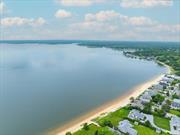 Your North Fork dream is now a reality.. Your private (members only) sugar sandy beach on the Bay at Simmons Pt.....the warm sun with a pleasant breeze on the Bay... no rocks or bulkheads to interrupt your strolling, jogging and viewing of a magical sunset inviting you to a calm evening.... across to your home, an amazing property for those looking for charm with exquisite attention to detail, a warm and inviting atmosphere. It is of quality construction featuring a spacious entryway into a welcoming living area complete with imported Danish wood burning fireplace leading to kitchen with Bluestar professional style gas range and new refrigerator.  Dining area complete with room for all. The primary bedroom with ensuite is oversized with seating/dressing area....Two large bedrooms with full hall bath. The entire home is filled with sunlight due to newly installed oversized windows throughout. This perfect home is set upon a full acre of lush mature landscaping organically maintained affording privacy and outdoor enjoyment be it quiet solitude or robust family  friend enjoyment. Existing Inground sprinkler system. Room for a pool. Huge 3-car barn could be guest quarters, home business, a multitude of uses. Barn is towards the rear of the acre property which is bordered by an organic farm. Solar panels owned, new roof & windows in 2023, new oil furnace 2024, wood floors and chef&rsquo;s kitchen. Outdoor shower.