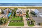 Welcome to 451 Dune Road, a newly completed coastal masterpiece set on 0.70 acres with over 90 feet of pristine ocean frontage. This 4, 000 square foot home offers meticulously designed interiors with premium finishes throughout. The gourmet kitchen features sleek stone countertops and top of the line Wolf appliances, seamlessly flowing into open-concept living and dining areas that showcase panoramic ocean and bay views, filling the space with natural light. The residence includes four bedrooms, with two primary suites - one on each floor, three full baths, and one half bath. Enjoy the warmth of two gas fireplaces, one indoors and one outdoors. The second-floor lounge provides an ideal retreat for relaxation or casual gatherings. Step out onto the expansive 1, 125 square foot rear deck, where a 16&rsquo; by 14&rsquo; pool invites you for a refreshing dip. Your own beach access leads directly to the sand and surf, enhancing the oceanfront living experience. Practical features include a 400 square foot lower level garage offering ample storage space. Located close to Westhampton Beach&rsquo;s vibrant Main Street, this property offers easy access to a variety of shops, restaurants, and entertainment options. This brand new, meticulously designed home presents a rare opportunity to own a premier oceanfront property in one of the Hamptons&rsquo; most desirable locations on Dune Road. * House has been professionally stage.* New Construction - Taxes TBD.