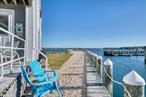 GREENPORT WATERFRONT CONDO . Enjoy your life in this well- appointed Bayfront 2 bedroom, 2 bath condo with stunning views of Shelter Island and Greenport Harbor. Amenities include a waterfront pool, tennis & pickle ball court, 200 Ft of private sandy bay beach, and your own boat slip in the private marina. Located just a short distance to shops and restaurants in Historic Greenport Village, ferry to Shelter Island for fun day trips and the Hampton Jitney or the LIRR train offer easy access to and from NYC. Everything you need is right here. Available Seasonal rates for 2026: May $7, 000, June $8, 000, Sept. $7, 000 , October $7, 000. Greenport rental permit #24-072 .