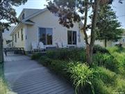 Magnificent Home in Kismet Fire Island. This is the first home built in Kismet constructed in 1925 by the founding Weis family whom created Kismet. This home was lovingly restored in 2004/2005. Special attention was given so as not to lose it&rsquo;s old world charm with details that were kept from the original build. This home was totally reconstructed with new roof, siding, sheetrock, plumbing, heating, 2 zone central air conditioning, 200 amp electrical service, kitchen, baths, insulation and more. There are 3 bedrooms upstairs with a den, bathroom, kitchen/bar area with additional fridge, washer dryer and 2nd floor deck. Downstairs you will find 3 additional bedrooms, a front porch/4th bedroom, huge living room with majestic fireplace, dining room, kitchen and wrap around trex deck with 2 gas grills and outdoor shower. The additional bunk house is an awesome extra as well. Property is high and dry. The home is elevated and was unaffected by Superstorm Sandy. Great investment. Includes all appliances and furnishings.