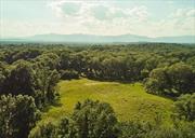 This exquisite 29-acre parcel in Tivoli, NY offers a harmonious blend of seclusion and natural beauty with an enchanting approach over a stone bridge and trickling stream. Comprised of two distinct tax lots, the crown jewel at the very end of serene Fox Ln comes with Board of Health approval for the construction of two homes (3-bed and 4-bed), two drilled wells and underground utilities at the start of the driveway, providing an extraordinary canvas for your vision of a tranquil retreat. As you meander down the quarter-mile driveway, through a wall of mature hardwoods, you are invited into a world apart. The heart of the property, a 13-acre expanse designated for the main home site, is a sanctuary of serenity. A gently rolling meadow presents a perfect tableau for your dream residence, framed on all sides by majestic trees that stand as silent sentinels, offering the ultimate in privacy and peace. Here, the expansive open skies and pastoral views create a backdrop of ever-changing beauty, while the gently rolling historic farmland evokes a timeless connection to the earth.  Located in charming Tivoli, this property enjoys a prime location that combines rural tranquility with convenient access to urban amenities. Tivoli, known for its artistic spirit and historic charm, offers a delightful array of quaint shops, cozy cafes, and vibrant community events. Just a short drive away, the picturesque village of Rhinebeck invites you to explore its renowned farmers market, fine dining establishments and boutique shopping. The cultural treasures of Bard College, including the acclaimed Fisher Center for the Performing Arts, are also within easy reach, providing a rich tapestry of intellectual and artistic pursuits. For those seeking a seamless connection to New York City, the property is conveniently situated near the Amtrak stations in both Rhinecliff and Hudson, ensuring an ideal retreat for those who desire the perfect balance between a peaceful rural lifestyle and the dynamic energy of the city.  Surrounded by the natural beauty of the Hudson Valley, with its rolling hills, lush forests and sparkling waterways, this land is a gateway to outdoor adventures and serene escapes. Whether you envision a weekend getaway or a permanent residence, this location offers a unique blend of seclusion, convenience and endless possibilities. This is not merely a place to live, but a place to belong, to create and to cherish.