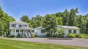 This spectacular Hudson Valley getaway is set among meticulous and beautifully landscaped grounds in one of the region&rsquo;s most exciting small towns. It is the epitome of country charm, elegance, and comfort, and it serves up a lifestyle filled with recreation and relaxation. Take a tour of 532 Springtown Road in New Paltz and imagine your life anew. A spacious 3-bedroom, 2.5-bathroom contemporary farmhouse, this completely updated home offers the perfect blend of privacy plus convenience for weekend retreats or full-time living plus an added bonus of income potential. The house, set deep within the almost 20 acre property, is revealed at the end of a long driveway that blends into in a circular parking area - this is where the fun starts: a landscaped firepit beckons on the expansive, open lawn; a luxurious, heated, saltwater pool presents endless summer fun; multi-level decking and a gorgeous stone patio adorned with roses and a lavender garden offer spaces for refined entertainment - here, you and your guests can forget the world, enjoying the natural beauty of the Hudson Valley that&rsquo;s on display from every vantage point and corner of this beautiful country acreage. Behind the house, the detached garages (one 2-car, and a second one-car) offer plenty of storage space for toys, tools, and vehicles. Enter through the home&rsquo;s porch into a sunny foyer large enough for lounging and conversation in front of the woodstove. Inside, you&rsquo;ll discover the open-concept living space which is the home&rsquo;s centerpiece attraction. Beautiful hardwood floors and ambient lighting flow between the gourmet kitchen, the cocktail bar, the entertainment room with its sunken hot tub and wood-burning fireplace, the luxurious full bath, and the office/guest bedroom. Nestled off the kitchen find the coffee bar to sip your morning roast and a separate laundry room. The main level is home to the private, primary bedroom, complete with seating areas, double closets, and an en suite bath. Upstairs you&rsquo;ll find two large bedrooms, each with hardwood flooring, plenty of windows, and ample closet space, as well as a third, full bathroom. Minutes to the delightful Village of New Paltz, you can begin your day on the deck to soak up the morning sun with your coffee, head into town to browse the charming local shops, cafes, and galleries, and visit the nature preserves (Mohonk, Minnewaska) and trails that draw people here from the city. Then return home at day&rsquo;s end to gaze up at the stars, watch the firefly show and toast s&rsquo;mores at the firepit. This is, quite simply, the perfect home, made extraordinarily perfect by income potential and the opportunity to purchase it furnished. Visit 532 Springtown Road in New Paltz - it will change your life.