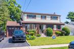 This magnificent 5-bedroom, 3-bathroom colonial home, with low property taxes, is located in the top award-winning Jericho School District. Conveniently situated on a quiet block close to shopping and transportation, it is within walking distance to the LIRR station. The house features a sunny southern exposure, an expanded living sunroom with backyard access, Anderson windows, an electric awning off the deck, and a home generator. The newly renovated eat-in kitchen and new hot water heater add modern touches to this classic home. With wood floors throughout, the house also includes a fully finished basement. The all-fenced yard offers privacy and is pet-friendly, while the flat lawn backyard provides a comfortable space for outdoor activities.