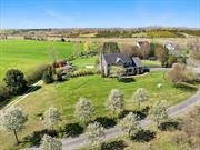 NORTH FORK CLASSIC Cedar Shingled Custom Farmhouse on Estate size 1.8+ acres! PRIVACY is yours along with Forever PRESERVED farm views! Short Distance to Iron Pier Beach (on the Long Island Sound), playground, and boat ramp! Newly renovated gourmet kitchen with tiled pantry. This open floor plan welcomes family and friends gathering together here. Experience farm to table dinners or read a book on the quiet front porch! Room for tennis court and pool or horses! Mini barn, greenhouse, and chicken coop too! 9-foot ceilings, custom crown moldings & hardwood floors. 4Bedrooms 2.5 baths plus dedicated office space. Park like setting with established specimen trees and gardens Commanding vistas from every room! Make this your forever home now!!!