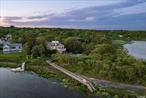 Situated on a picturesque quiet peninsula overlooking Shinnecock Bay all the way to the Ocean, this unique and very private 1.6 acre property has been just upgraded and renovated, including a brand-new full Chefs kitchen on the first floor, plus a new in-suite bedroom. Spectacular Post-Modern home featuring a total of 4 in-suite bedrooms, 5.5 full baths, steam shower, an open floor plan, living room, enjoy a primary ensuite with a fireplace and picture windows with the most spectacular water views, 2 chef&rsquo;s kitchens with top-of-the-line appliances, you get stunning water views throughout the whole house. Additional amenities include a media room and game room with a pool table. The grounds feature lush landscaping with brand new designer lights, firepit, a heated gunite pool and spa overlooking the water, a private dock and mooring rights. This property faces South offering unobstructed views with the most amazing sunrises and sunsets. Enjoy the quiet and private unique peninsula location. Just less than 2.5 miles from the center of Southampton Village., Additional information: Interior Features:Guest Quarters, Lr/Dr