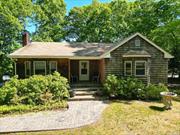 A classic Southampton, 2- bedroom ranch home, set on .92 densely wood acres is waiting for you. Backing up to farmland, the lot boasts 200 feet of frontage on Water Mill Towd Road. An eat in kitchen, dining room and living room with a wood burning fireplace creates an open concept lay out, ideal for entertaining. The spacious basement sports classic cedar paneling and provides direct entry to a one car garage. A 600 square foot outdoor deck provides ample seating and the perfect setting for sunning, barbequing and entertaining. Proximity to Noyack Road, makes for quick, easy trips to Sag Harbor, Watermill and Beaches for the ultimate Hampton&rsquo;s experience. The current house size and magnitude of the lot has great potential and allows for significant expansion possibilities. This is a must-see property!