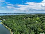 12 Acres of Waterfront Land with Multiple Cottages and Pools on Property. Gated. The land is 450ft facing Mill Neck Creek. A FABOULOUS BUILDABLE LOT FOR ANYONE LOOKING TO BUILD THEIR DREAM HOME!