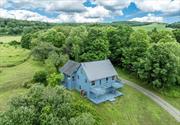 Hudson Valley private hillside retreat with south western mountain views. Quiet and special, this is located in the desirable Shekomeko Valley. This contemporary country home is on over 30 bucolic acres. Set well off the beautiful country road, the driveway leads to this renovated haven. Gorgeous vistas of countryside farms and mountains, the landscaping allows for relaxing exploration and exercise through walking paths, pastoral fields and glorious natural vegetation. Exterior wide decking provide additional vantage points for the spectacular surroundings. Entering the house you will see thoughtful stylish design bathed in bright natural light. There are wide-board pine and hardwood maple floors. The Great Room includes vaulted and beamed ceiling living and dining spaces, featuring a wood-burning stove. The galley kitchen is open and cheerful with up to date appliances. Glass door with wooden screen door takes you out to one of the decks from here. All bathrooms are fully renovated with accent lighting. Also on this level is the Primary bedroom which includes a wonderful wall of windows and cathedral beamed ceiling. A loft up top brings an additional bedroom with vaulted ceiling. The lower entry level provides charming screen door, the foyer and additional bedroom with glass slider and another full size bathroom. An exercise room and car garage is also accessed here. Also included is the use of a custom gym nearby with self guided mirror trainer program. Yoga teacher, Personal Chef and Physical Therapy also upon request. Nearby towns of Pine Plains, Millbrook, Rhinebeck, Millerton and Sharon CT. all provide excellent dining and shopping. This is all just two hours from New York. Train service provided by Metro North or Amtrak. Experience the Hudson Valley!