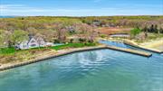 Southold, Paradise Point Bayfront. Private peninsula in Paradise Point Community. Water on 3 sides with sweeping, open views across Southold Bay to Shelter Island and beyond. This unique waterfront setting includes 994 feet of shoreline and a deep-water dock in a protected boat basin. Approach this 5, 100 sq. ft. home from the circular drive. Beautiful plantings frame the entry. Step into the grand entry foyer of this 2 story, 4 bedroom, 3.5 bath Nantucket style residence, with views through the foyer and house onto the open bay. A dramatic and exquisite first impression. High ceilings, huge gracious rooms. An open first floor design, living room with wood burning fireplace. Expansive windows, glass doors and transoms allow flow to the large outside wrap around waterside porch. Incredible light, and extraordinary sunset views. Oak floors throughout. First floor sitting room with gas fireplace and an office/den alcove. Huge chef&rsquo;s kitchen, with stainless appliances and granite counters, overlooking the bay and pool. Space for casual dining in kitchen, and a formal dining room overlooking the boat basin. Laundry room, one bayside en-suite primary bedroom, and an additional half bath complete the first floor. Second floor primary en-suite bedroom and sitting room with magnificent views over the pool and open bay. 2 additional large bedrooms with water views and additional full bath. The open second floor landing boasts sweeping water views. Elevator accessed by 3 floors, generator, spacious walkout basement waiting for your imagination with endless possibilities.  Waterside heated pool and 2 car garage. 1.8 acres. Specimen plantings. Beautiful shoreline landscaping. If you are looking for an exceptional home and property, this is it.