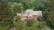 Designed by renowned architect Lewis Boman in 1929, this beautifully renovated and re-designed Tudor exudes timeless elegance and old world charm. This magnificent home situated on Siwanoy&rsquo;s award winning golf course, presents a rare opportunity to own one of the areas finest Tudors combining notable architectural details with modern amenities to create a timeless aesthetic. Lovely slate entry hall opens to a jaw dropping Great Room with 25 foot beamed ceilings, a majestic limestone fireplace, hand pegged oak floors and gorgeous leaded glass windows. Living Room opens to a sparkling 4 season Sunroom with 3 walls of windows and leaded glass doors. Off the Great Room is a cozy den with built in cabinetry. The gracious formal Dining Room leads to a gourmet eat-in Kitchen with large marble island, high end appliances, custom bar and sitting area. The 2nd floor boasts a luxurious primary suite with sitting room, lovely marble bath and walk in closet. 4 additional bedrooms on the 2nd floor, 2 with baths en-suite. One of the 4 bedrooms has been converted into a jewel like walk in closet/dressing room to complement the primary bedroom suite. The 3rd floor offers the 6th bedroom, beautiful en-suite bath and large window seat overlooking Siwanoy&rsquo;s 12th fairway. The totally re-configured lower level (1, 043 sf not included in square footage) includes a handsome Theatre with stadium seating, gym area, laundry room and half bath. Landscaping was completed in 2016 and includes specimen plantings, beautiful gardens and spectacular landscape lighting that magically transforms the home to a stunning work of art come dusk. 5 Rittenhouse is truly a treasure!