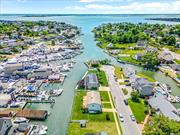 Welcome to this Waterfront Hi-Ranch with 99&rsquo; of Bulkheading (Approx 15 Yrs Old) On Canal. Updated Open Concept Eat-In Kitchen with a Beachy Feel Perfect for this Location. Granite Countertops and Butcher Block Island Connect To Dining Room W/Andersen Sliders to the Custom Built Upper Deck Which Spans The Length Of The Home. Outdoor Space Is Perfect For Entertaining With Views of the Open Bay. Light & Bright King Size Primary Bedroom with Private Sliders to the Upper Deck as Well to Watch the Sunrise. Roof, Kitchen and Heating System Under 12 Years Old. 200 AMP Electric. Brand New Water Heater. Newly Updated Ground Floor Offers A Bedroom PLUS An Office, Large Den & Full Bath With Access to Fenced Yard. Utility Room Has Washer/Dryer Hook Up. Gas On Street. Flood Insurance Required - Approx 3, 500/year.