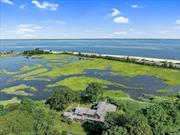 DRAMATIC PRICE REDUCTION!!! Over $250, 000!!!. It is a must see! An incredible 2 acre property overlooking the Long Island Sound, wetlands, tidal creek and abuts Oyster Bay National Wildlife Refuge with magnificent sunset views. Watch the tides come and go along with breathtaking wildlife. Custom built in the 80&rsquo;s, redesigned and rebuilt in 2002. Two story spacious Entry Hall sets the tone for this very special home. Every room is filled with light! Many have access to the wonderful porches. Two Primary Bedrooms with ensuite baths. First Floor primary has a new handicapped bathroom. Many unusual ceiling heights throughout. A home built for entertainment and gracious living. The heated gunite pool has slate and herringbone design. A home for the traditional family or the multigenerational family.