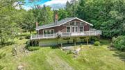 Located in the Catskill Mountains minutes away from skiing, hiking trails and so much more! This four-bedroom, two-bathroom home sits on cud-de-sac featuring over spacious six-acre lot, offering plenty of room for privacy and outdoor activities. The style of the house is a charming blend of ranch and chalet architecture, combining the simplicity of a ranch design with the cozy, rustic elements typically found in a chalet. As you approach the home, you are greeted by a welcoming exterior featuring elements such as large windows, wrap around deck, natural wood siding, and perhaps a sloping roofline reminiscent of a chalet. The interior of the house is likely to feature an open layout with a comfortable living room, a well-appointed kitchen and a dining area perfect for family meals and entertaining guests. The four bedrooms provide ample space for a family or guests, and the two bathrooms offer convenience and comfort. The large windows throughout the house allow plenty of natural light to flood the interior, creating a warm and inviting atmosphere. Outside, the six-acre lot provides endless possibilities for outdoor enjoyment, whether it&rsquo;s gardening, hosting gatherings, or simply enjoying the peaceful surroundings. The ranch chalet style of this home combines the best of both worlds, offering a cozy and inviting retreat in a beautiful natural setting. Additional Information: ParkingFeatures:2 Car Detached,