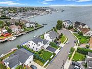 This stunning residence on Harbor Rd exudes opulence and meticulous attention to detail. The gourmet chef&rsquo;s kitchen features custom cabinetry, Sub Zero Wolf appliances, and natural stone countertops, while the primary bedroom suite with a walk-in closet offers stunning views of the Bay and Jones Beach amphitheatre. The exterior is just as enchanting, with Brazilian walnut decking, glass/stainless steel railings, and meticulously manicured landscaping. This home boasts four bedrooms, four full bathrooms, a recreation room, office/sitting area, and ample storage space, with top-of-the-line features like Andersen fiberglass windows and doors, pristine hardwood floors, and a Savant home audio/video system. Located in the highly desired Merrick School District, this home offers easy access to major roadways, shopping, and beaches, with ocean access only minutes away. Own this impressive luxury home and enjoy the South Shore Waterfront Lifestyle every day!