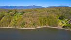 Hudson River Waterfront! An extraordinary opportunity awaits to build your dream home. Spanning 5.4 acres, this lot boasts 200 feet of pristine river frontage. Unlike many other properties along the Hudson, this lot is free from the obstruction of railroad tracks, offering unspoiled views and direct access to the river. The road to the property has been roughed in, electricity is already buried on-site, and permits for a boat ramp and dock have been previously granted. The neighboring lot is also for sale and offers an additional 2.2 acres. These lots can be bundled, giving you a combined total of 7.6 acres. This additional space expands the possibilities for creating a private, expansive estate.