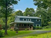 Welcome to 34 Turkey Hollow: a charming, three bedroom (plus multiple bonus spaces!) farmhouse offering tranquil privacy just fifteen minutes outside Livingston Manor in the Western Catskills. You&rsquo;ll first notice the generous wraparound porch when you pull into the drive of this privately-set home. It&rsquo;s easy to imagine many a morning coffee or evening cocktail enjoyed in this tranquil setting. Through the front entrance, you find yourself in the kitchen, whose highlights include a large stone fireplace. This opens onto the cozy living room with built in cabinets and second door onto the deck. Down the hall is the first of two full bathrooms, plus a large first floor bedroom and additional private room that could function as another bedroom or a private office. Heading upstairs you&rsquo;ll find four more large rooms plus a generous full bath that connects to one of the bedrooms as well as the hallway. There&rsquo;s plenty of room to sleep a crowd!Housed separately from the main home is a large two story, four car garage. The second story is currently unfinished storage space, but it&rsquo;s easy to imagine this building being home to a future studio or workshop. Just bring your imagination! A small free-standing shed offers room to store your lawn and garden supplies. Just five minutes from James Beard-nominated The DeBruce, fifteen minutes from all the attractions of Livingston Manor, and two hours from the George W. bridge, 34 Turkey Hollow makes a great place to call home!