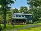 Welcome to 34 Turkey Hollow: a charming, three bedroom (plus multiple bonus spaces!) farmhouse offering tranquil privacy just fifteen minutes outside Livingston Manor in the Western Catskills. Youâ€™ll first notice the generous wraparound porch when you pull into the drive of this privately-set home. Itâ€™s easy to imagine many a morning coffee or evening cocktail enjoyed in this tranquil setting. Through the front entrance, you find yourself in the kitchen, whose highlights include a large stone fireplace. This opens onto the cozy living room with built in cabinets and second door onto the deck. Down the hall is the first of two full bathrooms, plus a large first floor bedroom and additional private room that could function as another bedroom or a private office. Heading upstairs youâ€™ll find four more large rooms plus a generous full bath that connects to one of the bedrooms as well as the hallway. Thereâ€™s plenty of room to sleep a crowd!Housed separately from the main home is a large two story, four car garage. The second story is currently unfinished storage space, but itâ€™s easy to imagine this building being home to a future studio or workshop. Just bring your imagination! A small free-standing shed offers room to store your lawn and garden supplies. Just five minutes from James Beard-nominated The DeBruce, fifteen minutes from all the attractions of Livingston Manor, and two hours from the George W. bridge, 34 Turkey Hollow makes a great place to call home! Additional Information: ParkingFeatures:4+ Car Detached,