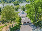 Welcome to a unique sanctuary that marries expert design with masterful craftsmanship in every detail. This lakefront home greets you with a welcoming lodge-style entry, leading to an open and flexible floor plan that epitomizes resort-style living. Architectural highlights include exposed structural wood beams, vaulted ceilings, walls of windows, French doors, reclaimed dark wood flooring, and magnificent stone fireplaces, all contributing to the rustic charm of this sophisticated country residence. Inside, the bespoke home boasts a true chef&rsquo;s kitchen, spa-like bathrooms, and an exquisite built-in custom bar. Enjoy the serenity and beauty of Truesdale Lake from multiple vantage points: the wrap-around deck on the main level, the patio with a wood-burning fireplace and pizza oven on the lower level, or the balcony off the primary suite. The exterior is equally captivating, featuring tiered French gardens with a mid-level terrace and stone walls that enhance the sublime views of the lake. The lakeside lawn includes a stone fire-pit and a transformed shed bar, perfect for entertaining. This eco-friendly property also offers radiant heat floors throughout, a state-of-the-art air filtration system, an automatic standby generator, and many other special features. Located within the sought-after Katonah-Lewisboro school district, this well maintained home is a rare opportunity you don&rsquo;t want to miss!