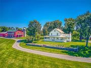 Live the dream on a dreamy farm. Relax and enjoy almost 93 acres of some of the most beautiful land the Hudson Valley has to offer with a picture-perfect farmhouse, multiple barns, a large guest loft for gathering & entertaining, cinematic long-range views, and a massive spring-fed, refreshing pond w/pond cottage. The entire property is pristine and impeccably maintained. Mature trees, stone walls, and even a classic rocking chair front porch are all waiting for your pleasure. The Keene Farm has been sitting proudly for over a century and has been well-loved since 1914. A light-filled chefs kitchen, large open LR, formal DR, front parlor, and comfortable bedrooms provide a wonderful place to live, while the acreage and barns provide adventure and places to grow or create. Located just minutes from Kinderhook and a short drive to Hudson. This is a very special property and an opportunity to acquire a turn-key dream farm.