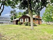 Ranch home in Smithtown, situated on .35 acres, features an eat-in kitchen, a living room with a fireplace, three bedrooms, a full bathroom, a full basement, and a 1-car garage.