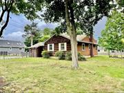 Ranch home in Smithtown, situated on .35 acres, features an eat-in kitchen, a living room with a fireplace, three bedrooms, a full bathroom, a full basement, and a 1-car garage.