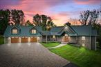 This Contemporary Mountain Lodge offers the perfect blend of luxury and rustic charm. Step into this grand living space with cathedral ceilings, floor to ceiling windows and a stunning two-sided fieldstone fireplace. The gourmet kitchen features top-of-the-line appliances, custom hickory cabinets, black marble countertops and a walk-in pantry. Enjoy the convenience of a large mudroom, a 3 bay heated attached garage with a dog bath for your furry friends. An expansive finished room over the attached garage provides endless opportunities for housing guests in bunk room fashion, or as a large game/media room for entertaining. Need more garage space, no problem, because the property also has a detached 3 bay heated garage. The attached and detached garages are both equipped with 220 Volt outlets for EV charging stations and special LED lighting to highlight your many vehicles. Experience ultimate comfort with Geothermal radiant heated hardwood floors and a 30KW Generac generator ensuring your home is always powered. Relax on the 60 ft wrap-around Timbertech deck or at the stocked fishing pond. Spend your nights on the back flagstone patio around the built in fire pit with family and friends. This 56 acre estate includes a .25 acre 9 ft. fenced area for gardening with a small orchard of apple and pear trees. Property boasts approximately 10 acres of 9 ft. fenced-in land suitable for livestock. Light Sport Aircraft, Horse and livestock friendly land. EQUIPMENT THAT CONVEYS WITH THE PROPERTY: Polaris Ranger, Kubota ZD323 Zero Turn, Kubota L3400 Tractor, Land Pride Brush Hog, Land Pride Tiller Additional Information: Amenities:Storage, ParkingFeatures:3 Car Attached, 3 Car Detached,