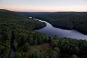 Come build your dream home on one of the very few waterfront parcels on the Rio Reservoir, a protected and pristine 422 acre body of water. A large boulder on the shore makes a perfect spot for an idyllic afternoon swimming in its clear and refreshing water. The vista from the shore will never change, it is protected a DEC bald eagle conservation. Paddle across the reservoir to find a beautiful waterfall.  The 4.39 acre lot has a gentle slope off the road with a driveway already in place and a pretty perfect build site. Electric and internet can easily be pulled to the property from nearby utility poles. Two huge, age-wisened maple trees welcome a visitor, and pine, hawthorn, green apple and hickory trees are found lining the lovely open meadow. The two sheds are grandfathered and two more structures may be built per local code.Old stone walls on the property are romantic relics of the Drake Hotel, a rooming house in the late 1800s. There is an existing well on the property that could very likely be serviced and brought back to life. Located in Forestburgh, NY, just a 2 hour drive to the George Washington Bridge, near some of the best darn pizza in the area, Forage Pizza. There is a convenient NJ Transit train at Port Jervis just 20 minutes away. Bethel Woods Center for the Arts is a great venue for summer concerts and just 35 minutes away.