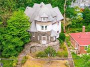 Discover the charm of this historic Victorian-style home in Yonkers&rsquo; coveted Park Hill neighborhood. This unique property boasts a symmetrical arrow-shaped exterior, setting it apart as a true architectural gem. Step inside to a stunning art deco-inspired circular lobby, leading to the first floor&rsquo;s sitting room, guest kitchen/dining area, full bathroom, and two bedrooms. The second floor features a kitchen and large living room with updated flooring, a spacious master bedroom, full bathroom, and another distinctive circular room. The third floor offers two more bedrooms, a full bathroom, and an additional circular room. The basement is perfect for entertaining, with a wet bar, half bathroom, kitchenette, separate walk-out entrance, laundry, and updated gas furnace. Enjoy the paved backyard and stone front porch. Conveniently located just a 5-minute drive from the Ludlow Metro-North train station, this home is truly one of a kind.